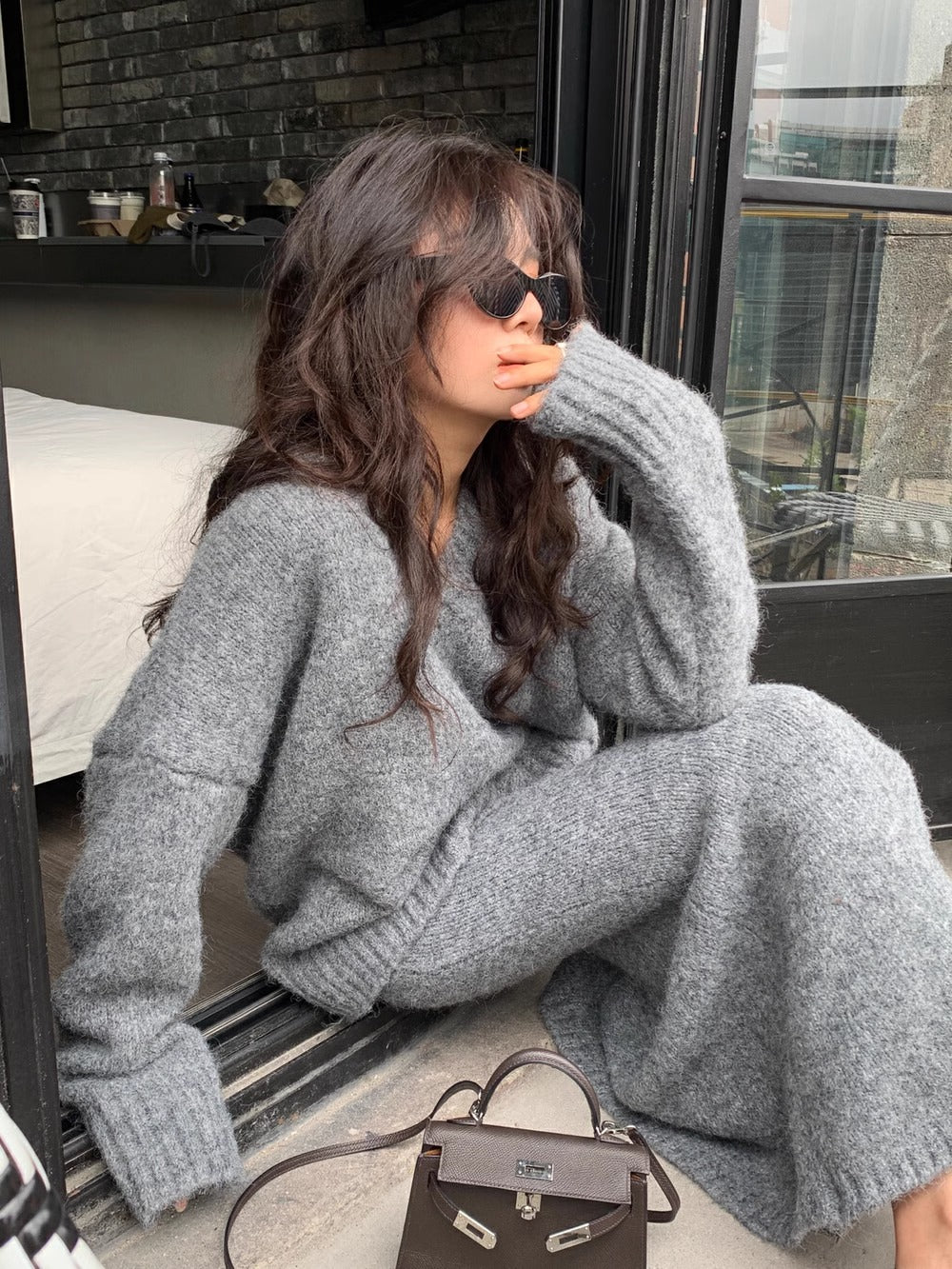 Stylish women's V-neck long sleeve knit sweater and midi skirt set, a fashionable matching two-piece outfit.