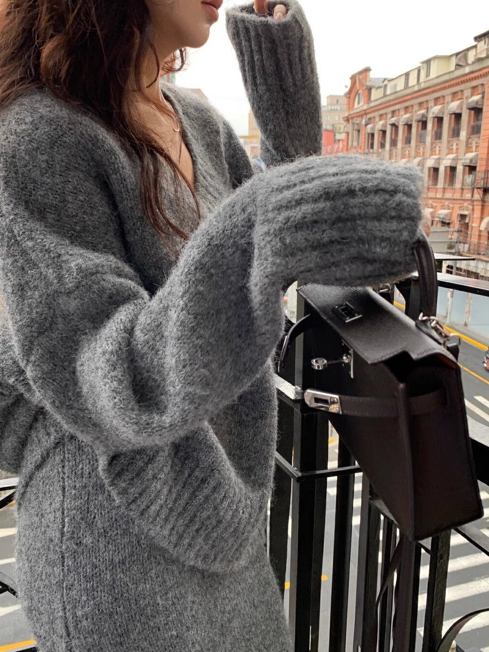 Women's two-piece V-neck knit sweater and midi skirt set, offering elegant style and comfort for daily wear.