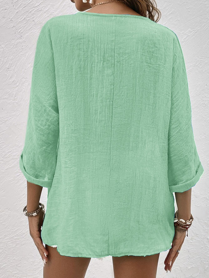 Female model in a relaxed fit V-neck long sleeve button-down shirt, showing its comfortable & casual style.