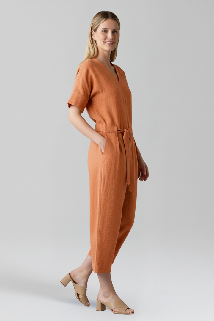 Elegant women's V-neck long sleeve jumpsuit, featuring wide legs and a flattering tie waist for any occasion.