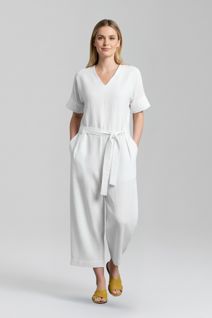 Full-length shot of a flowing women's wide leg jumpsuit with V-neck & long sleeves, ideal for modern women.