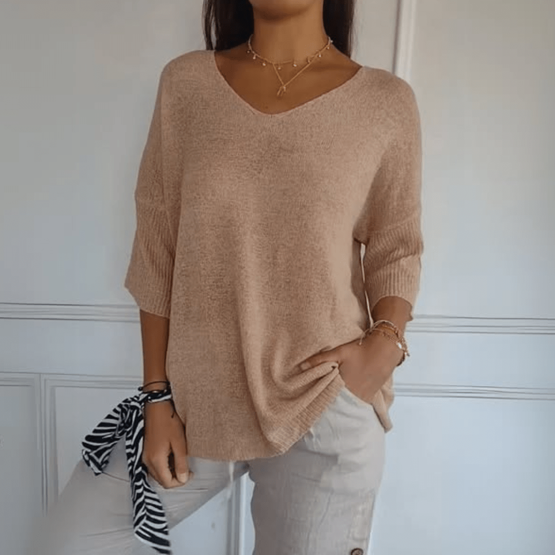 Relaxed silhouette V-neck women's sweater with 3/4 sleeves, ideal for fall & spring fashion.