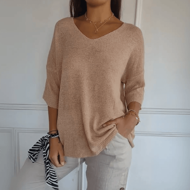 Relaxed silhouette V-neck women's sweater with 3/4 sleeves, ideal for fall & spring fashion.
