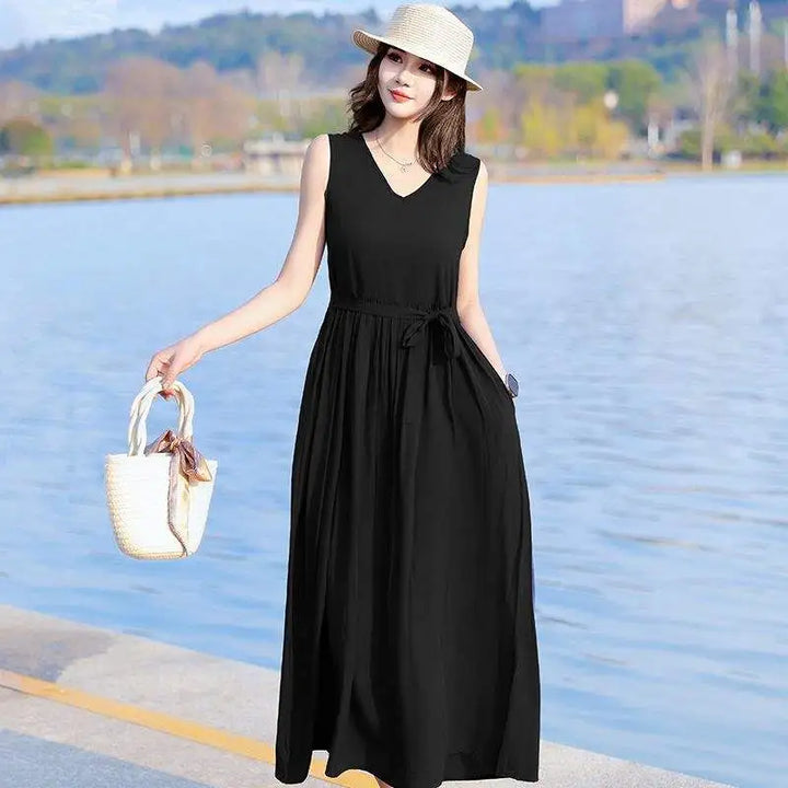 Elegant sleeveless V-neck maxi dress for women, featuring a flattering tie waist and functional pockets.