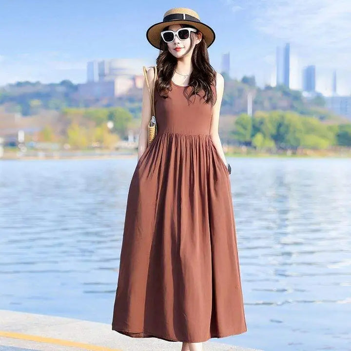 Flowy V-neck maxi dress with tie waist, offering comfort and style. Includes convenient side pockets.