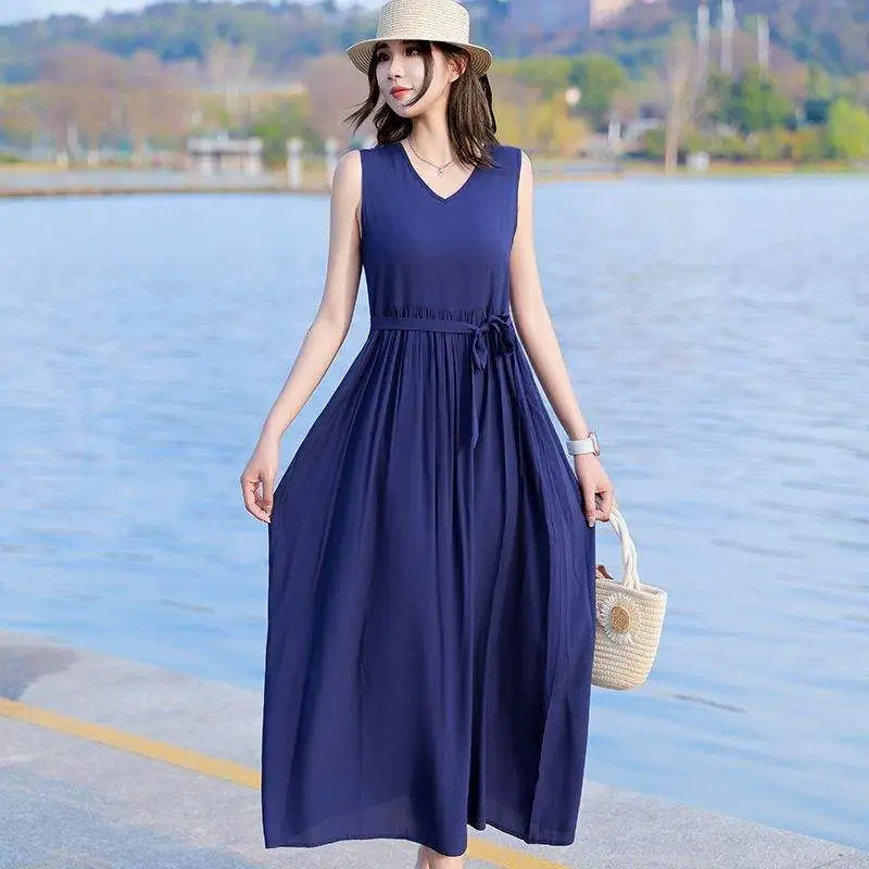 Plus size women's V-neck maxi dress with tie waist and pockets. A stylish, comfortable summer vacation dress.