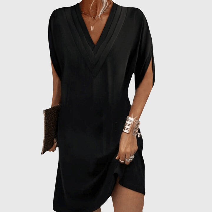 Women's V-neck mini dress with short sleeves. Relaxed fit for casual summer comfort, perfect for beach or vacation.
