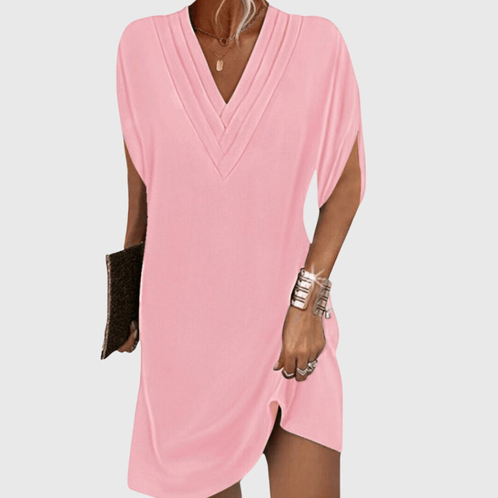 Casual women's short sleeve v-neck mini dress, perfect beachwear. Relaxed fit for comfortable summer vacation style.