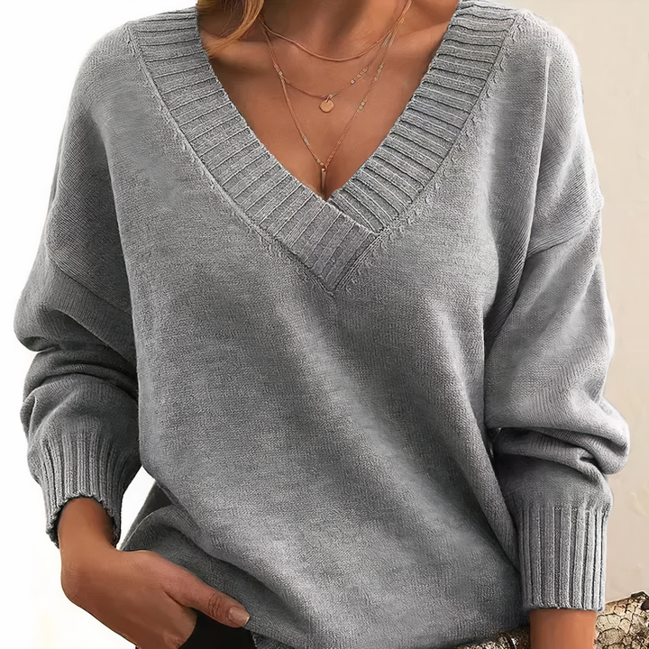 Soft women's ribbed V-neck sweater. Relaxed fit, long sleeve design for everyday wear.