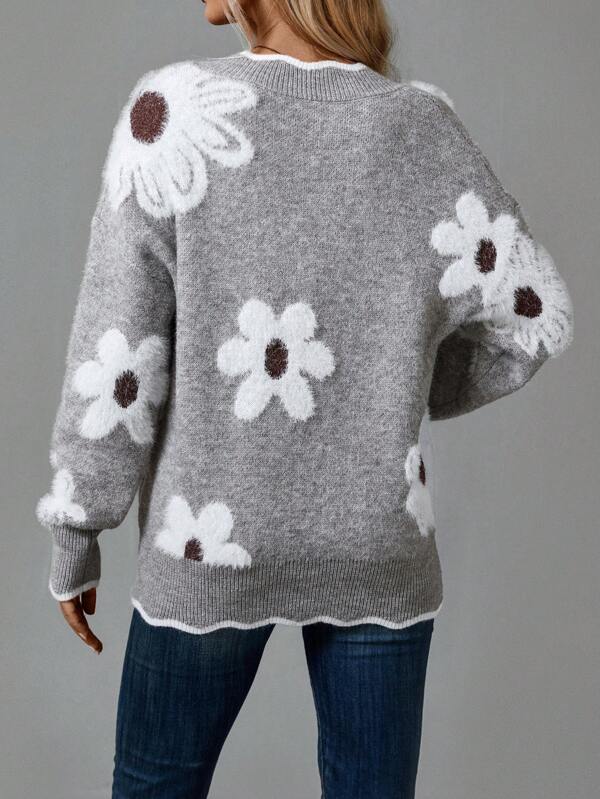 Close-up of women's V-neck jumper, showcasing unique textured floral details & soft knit fabric.