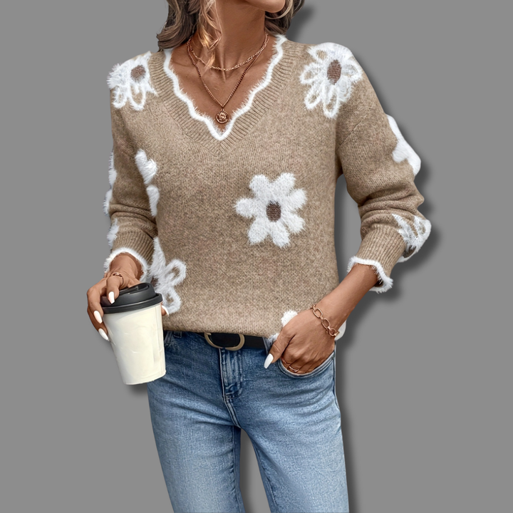 Stylish women's long-sleeve V-neck jumper featuring elegant textured floral accents. Casual comfort.