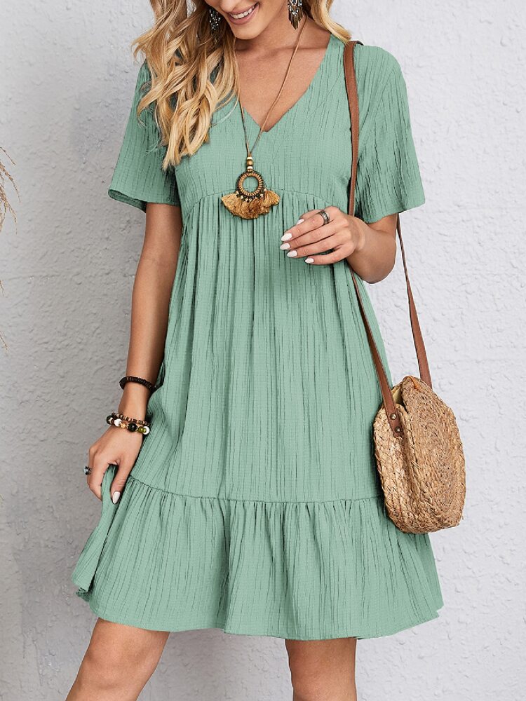 Effortlessly stylish women's V-neck tiered mini dress, short sleeve. Perfect casual summer fashion.