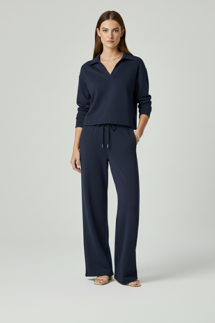 Women's set in motion: V-neck top & wide-leg trousers showing graceful drape. Stylish & comfortable fashion.