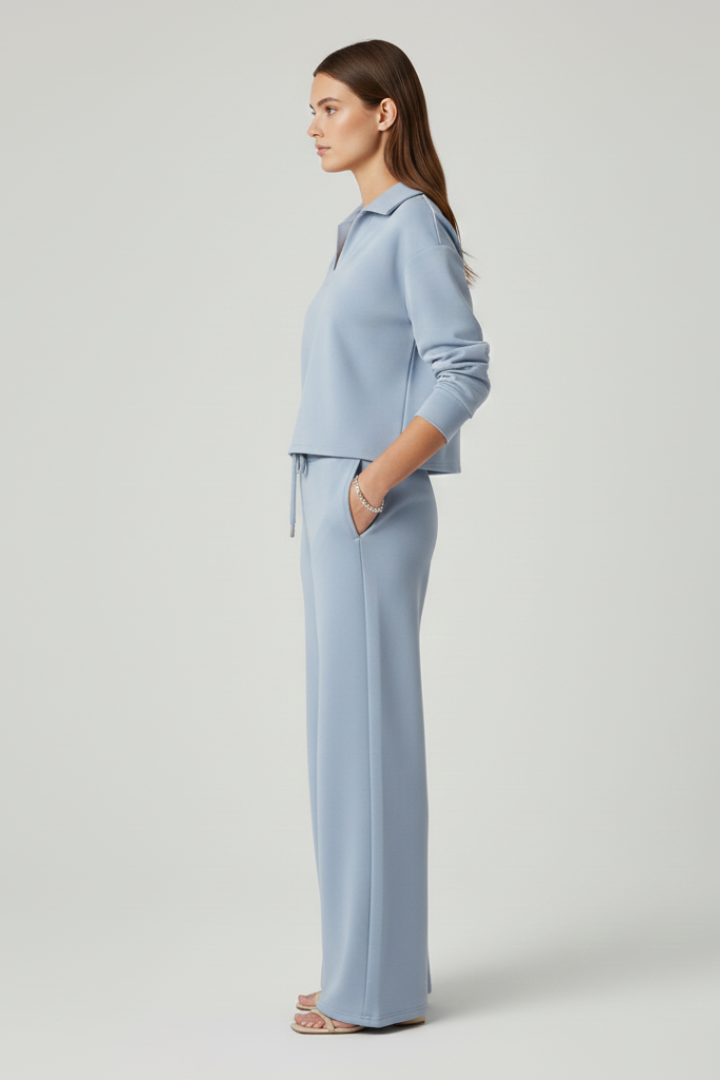 Effortlessly stylish women's V-neck top and wide-leg trousers set. Versatile work attire or chic casual outfit.