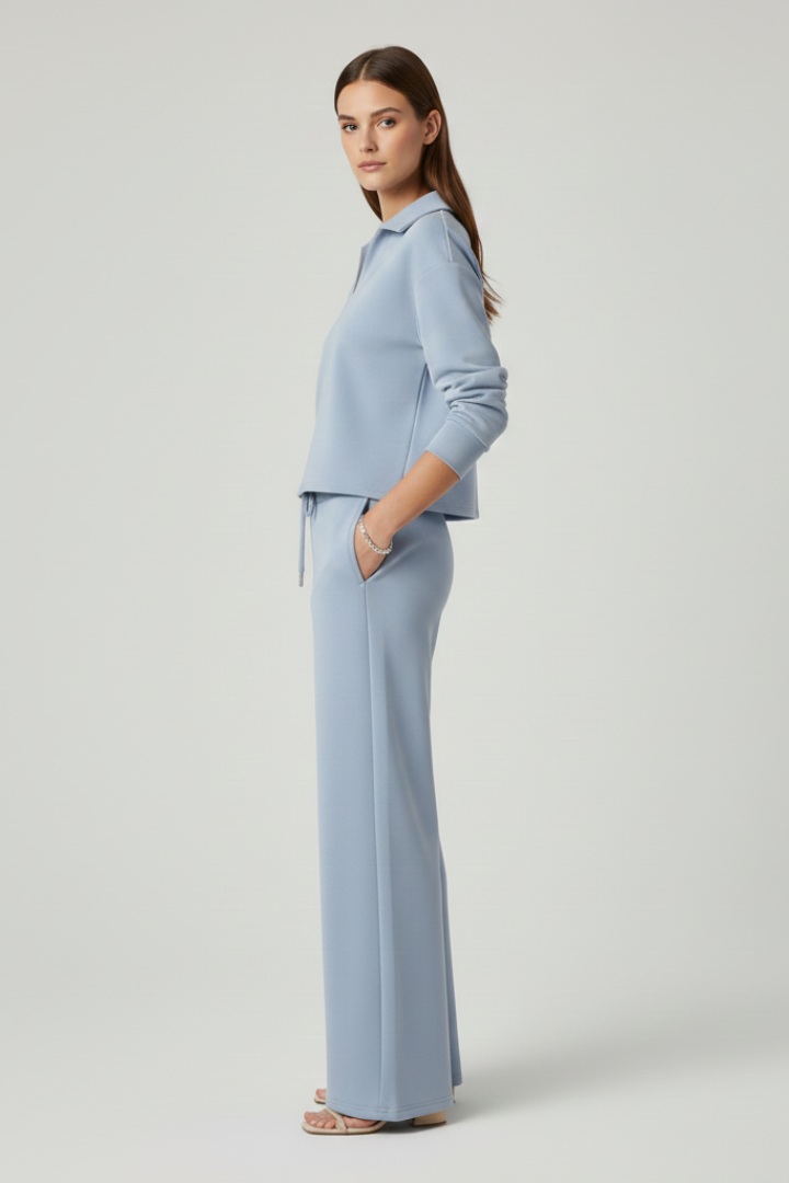 Elegant women's V-neck long sleeve top paired with flowing wide-leg trousers. A modern and comfortable set.