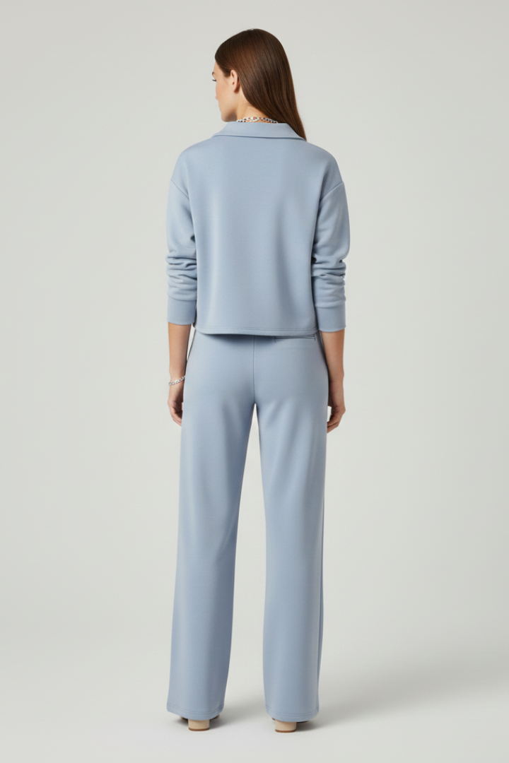 Women's comfortable two-piece set featuring a V-neck top and wide-leg pants with drawstring waist and pockets.