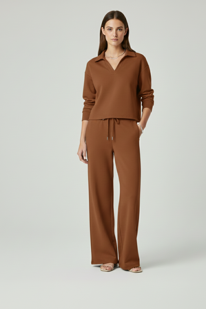 Detail shot of soft fabric on a women's V-neck top and wide-leg trousers set. High-quality comfortable wear.