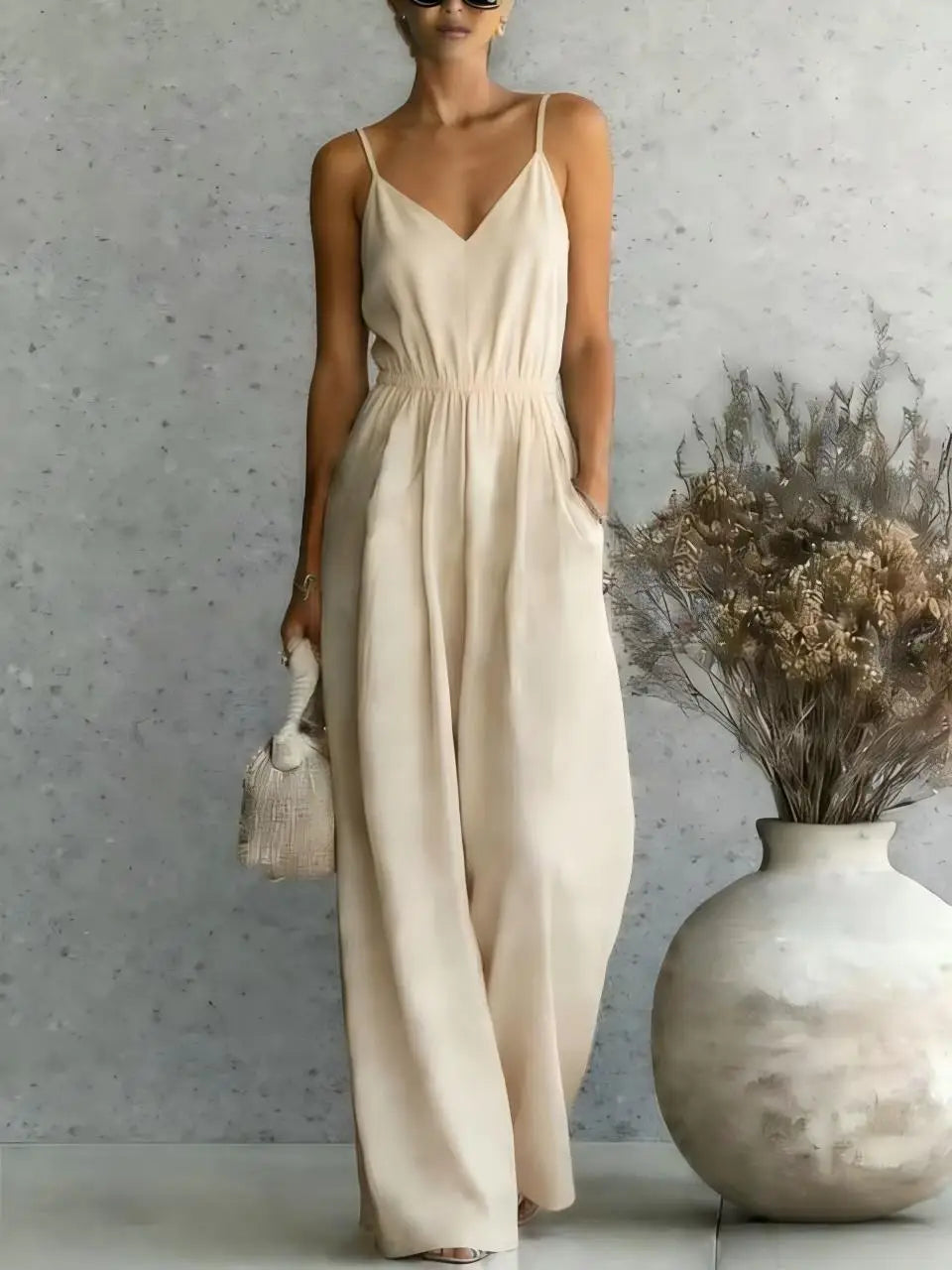 Relaxed fit women's V-neck wide leg jumpsuit. Comfortable sleeveless one-piece for casual wear.
