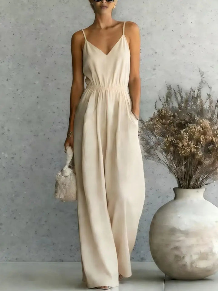 Relaxed fit women's V-neck wide leg jumpsuit. Comfortable sleeveless one-piece for casual wear.