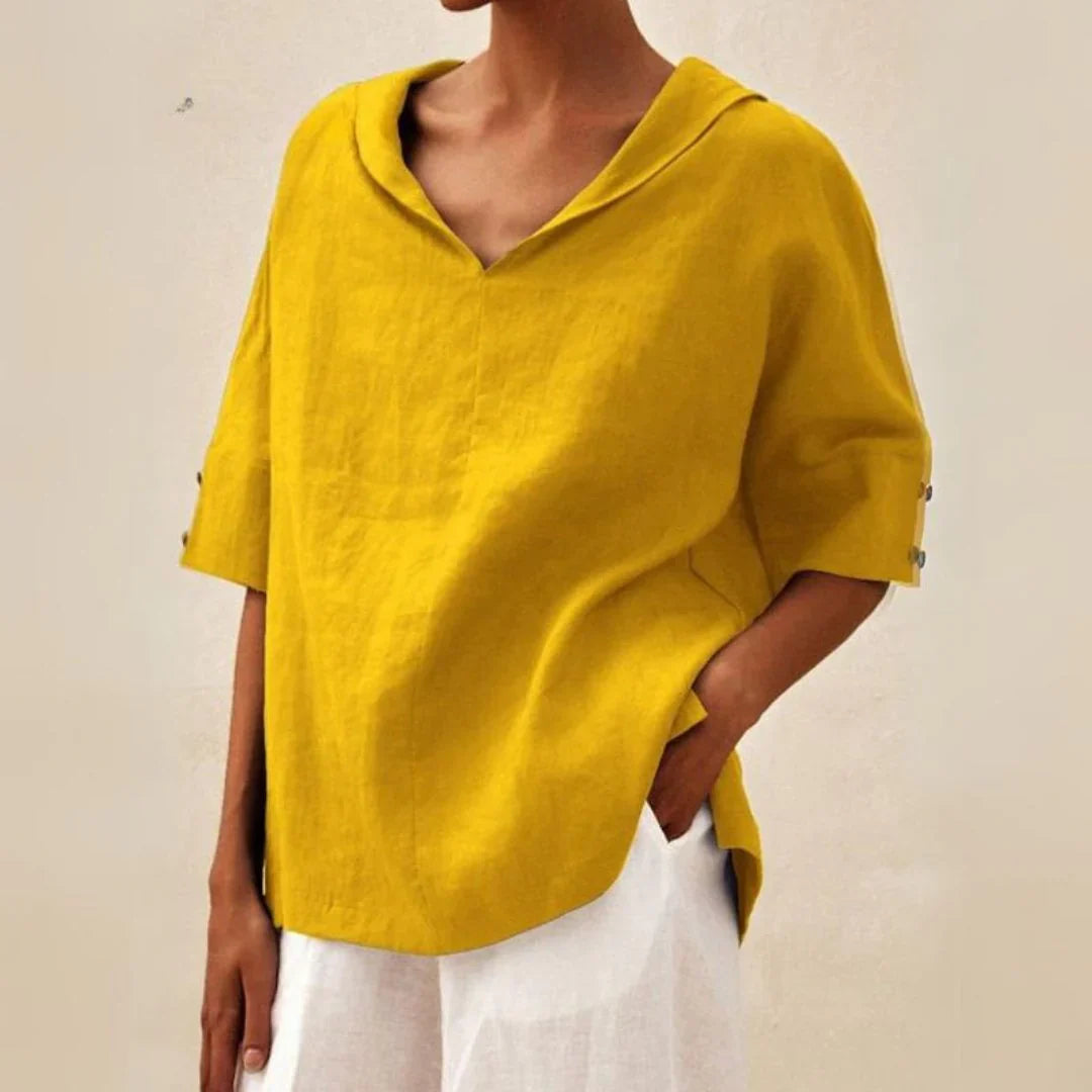 Fashionable women's summer shirt with functional roll-up sleeves, relaxed silhouette, and pointed collar.