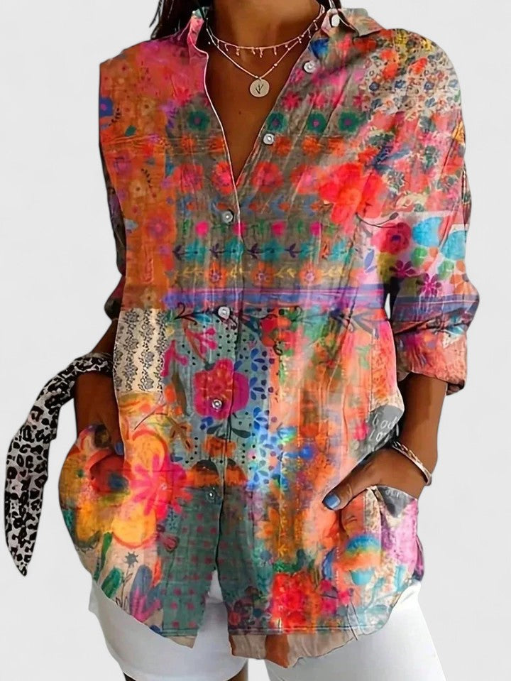 Effortless women's vibrant floral abstract blouse with roll-tab sleeves. Versatile, casual chic summer fashion.