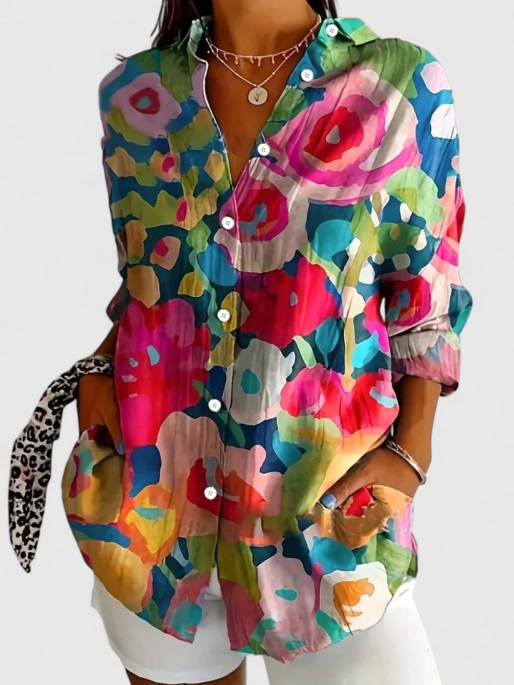 Women's vibrant floral abstract print blouse, relaxed fit, long roll-tab sleeves. Stylish and comfortable top.