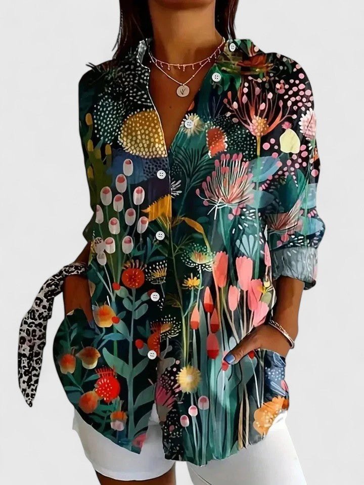 Chic women's vibrant floral abstract print blouse with roll-tab long sleeves. Casual, versatile, artistic style.