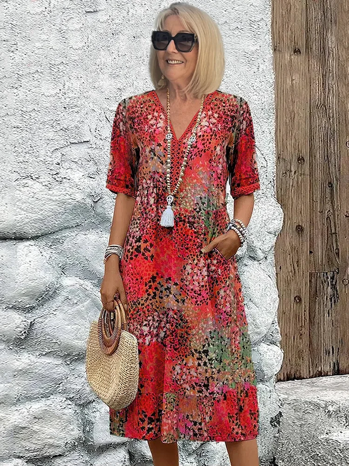 Women's vibrant print flowy midi dress with a colorful pattern, perfect for summer casual or elegant wear.