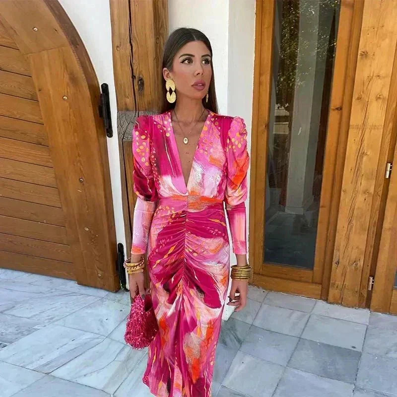 Women's vibrant printed ruched midi wedding guest dress with long sleeves & V-neck. Perfect for special occasions.