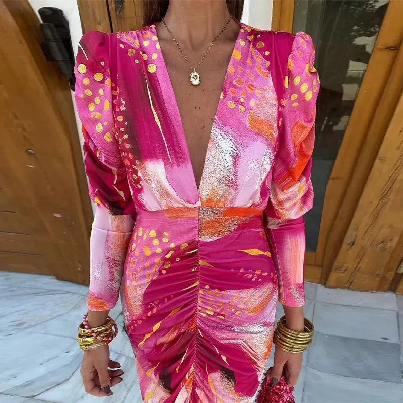 Elegant women's printed ruched midi dress for wedding guests. Features long sleeves, V-neck, and vibrant pattern.