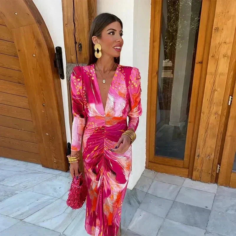 Chic women's long sleeve V-neck printed ruched midi cocktail dress. Ideal party or special occasion guest attire.
