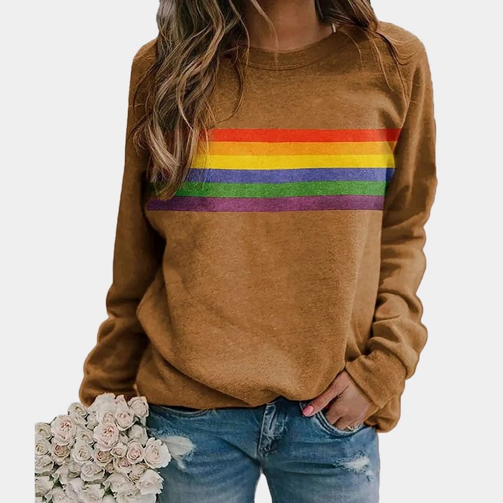 Close-up of a women's colorful rainbow stripe crewneck sweatshirt, showcasing the vibrant fabric and relaxed fit.