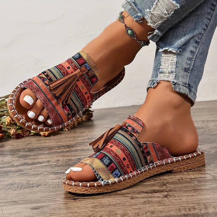 Stylish and comfortable women's flat sandals, perfect slip-on footwear for casual summer days.