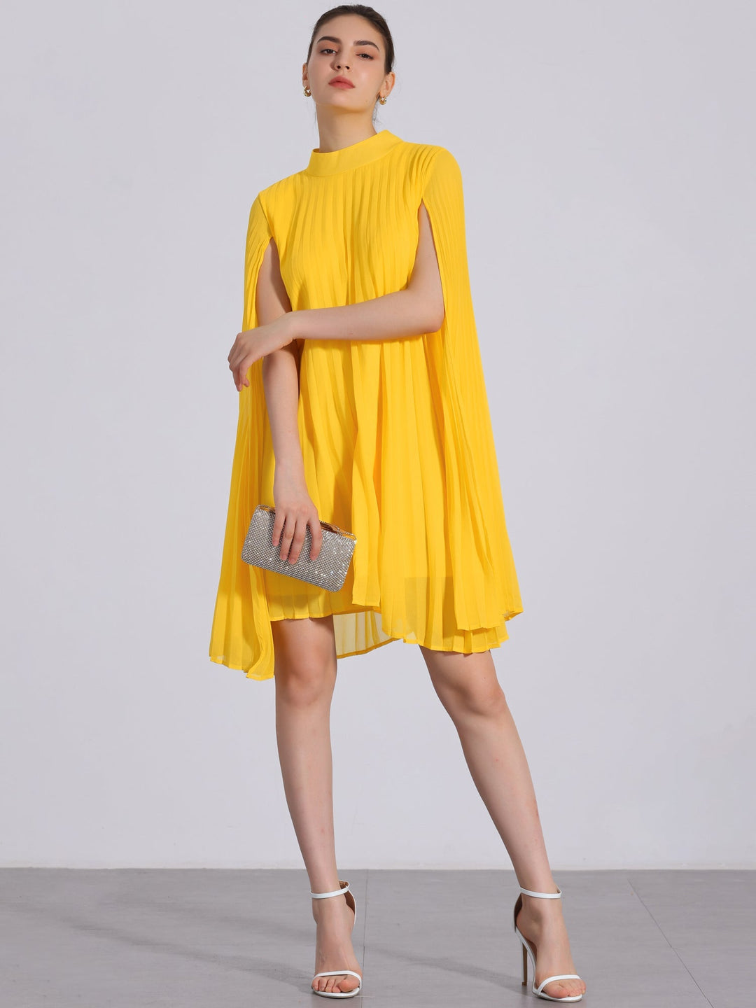 Women's vibrant yellow pleated swing dress with elegant cape sleeves & mock neck. Chic party or special occasion dress.