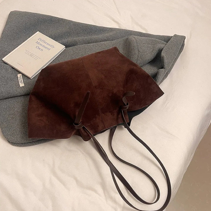 Open view of women's vintage faux suede tote handbag, revealing inner lining and spacious compartment