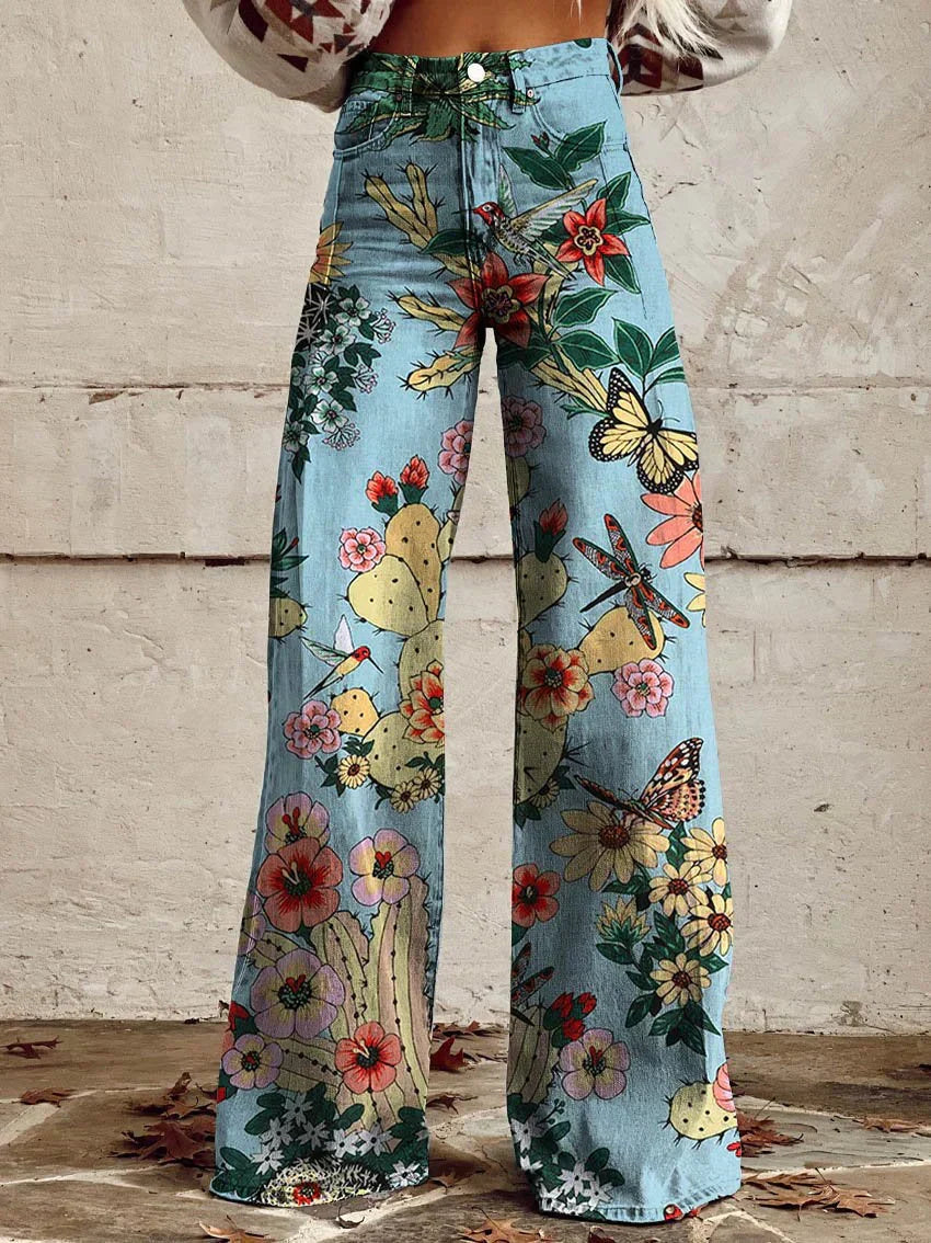 Retro fashion women's denim jeans with a vibrant vintage floral pattern & stylish wide-leg flare.