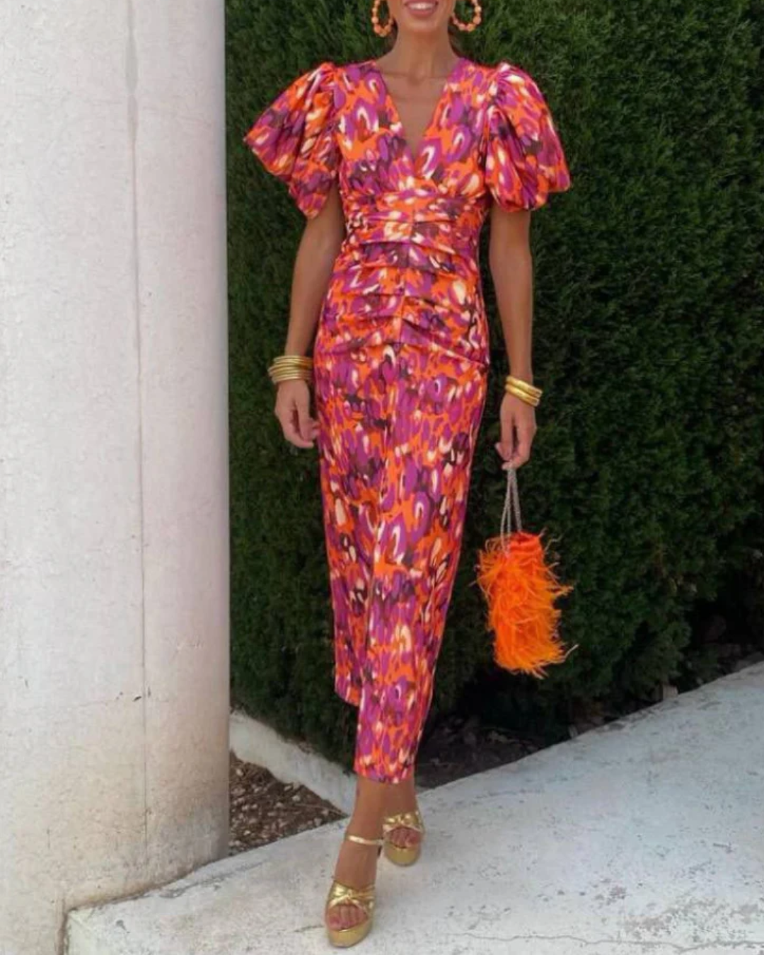 Women's vivid ruched midi dress with vibrant abstract print. Perfect elegant occasion wear or party dress.