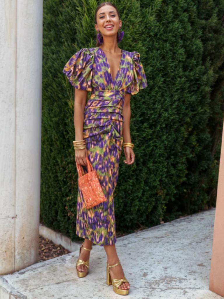Vibrant abstract print ruched midi dress for women. Elegant occasion wear, perfect as a party dress.