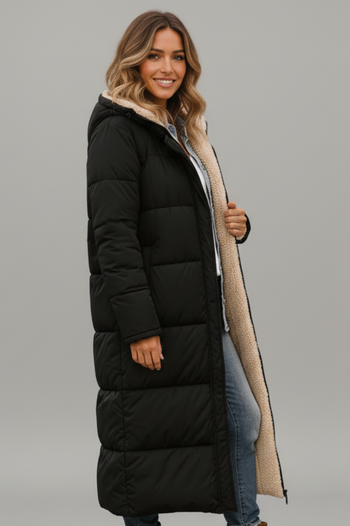 Stylish women's long quilted hooded coat with full zip. Essential warm outerwear for cold weather fashion.