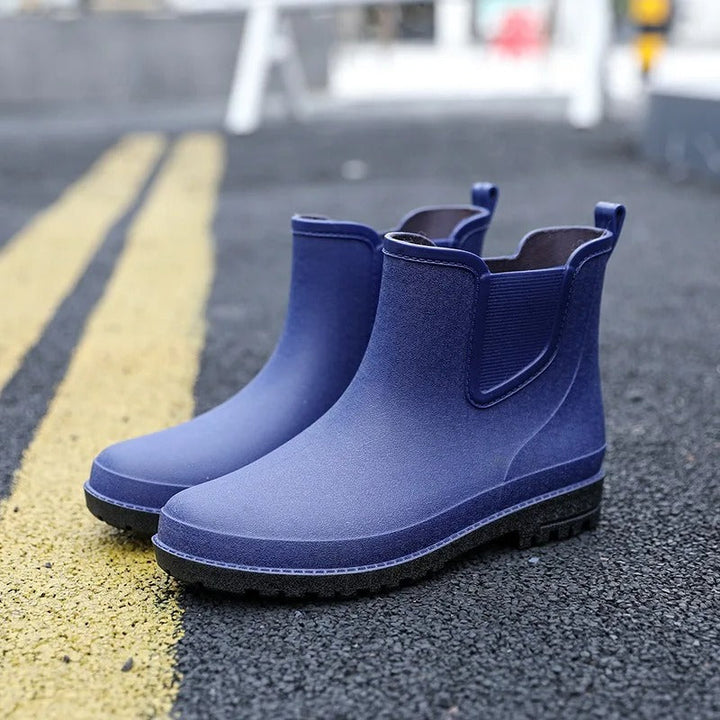Fashionable women's black waterproof Chelsea platform ankle rain boots. Comfortable slip-on design.