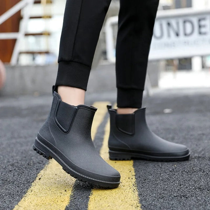 Modern women's black Chelsea platform ankle boots, waterproof & stylish for rain.