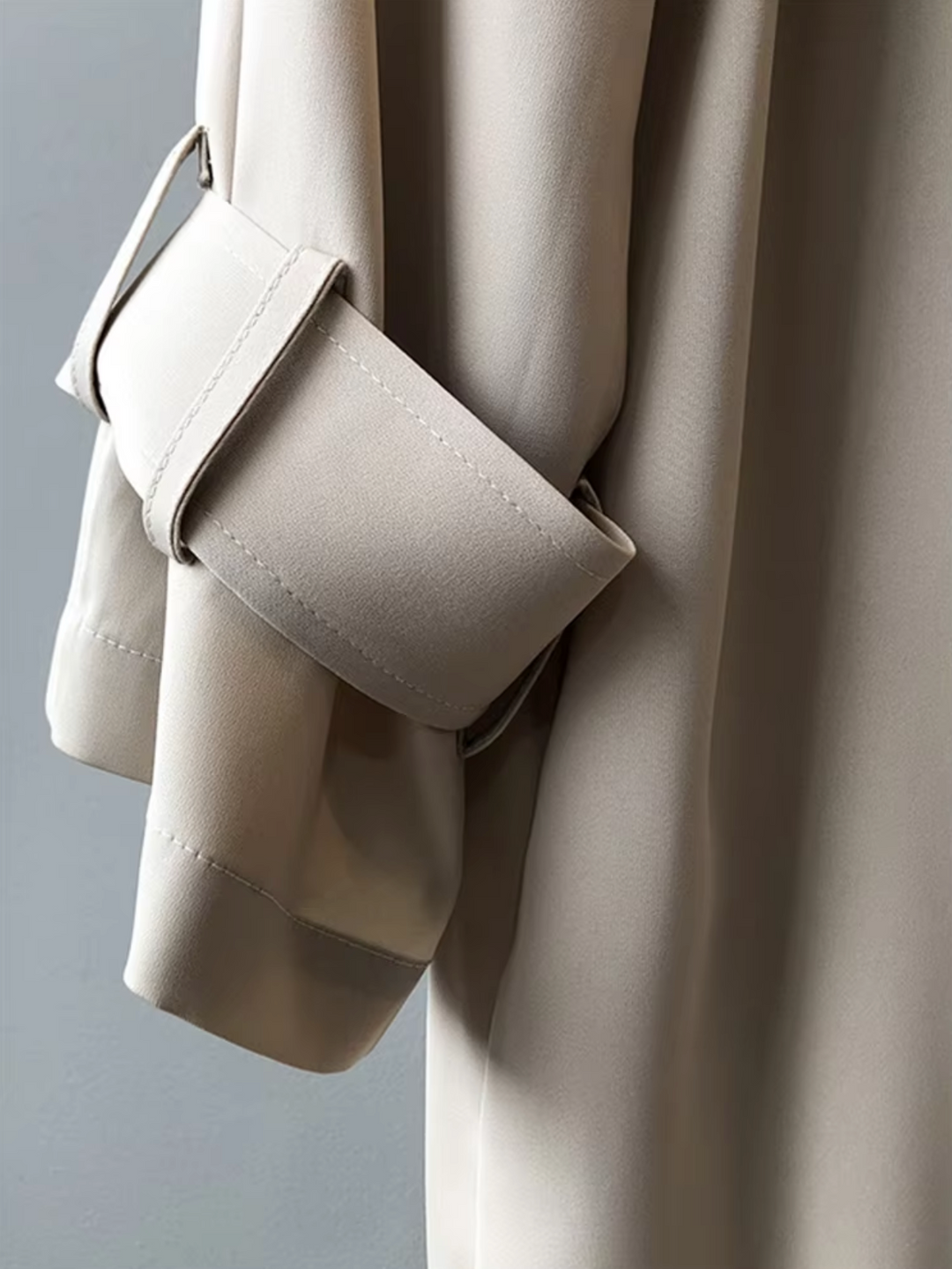 Classic women's double-breasted trench coat. Waterproof outerwear with a lapel collar, suitable for spring jackets.