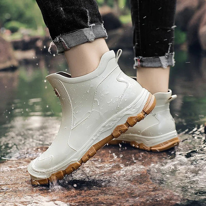 Fashionable women's waterproof Chelsea boots, practical slip-on ankle design for outdoor activities and rain.