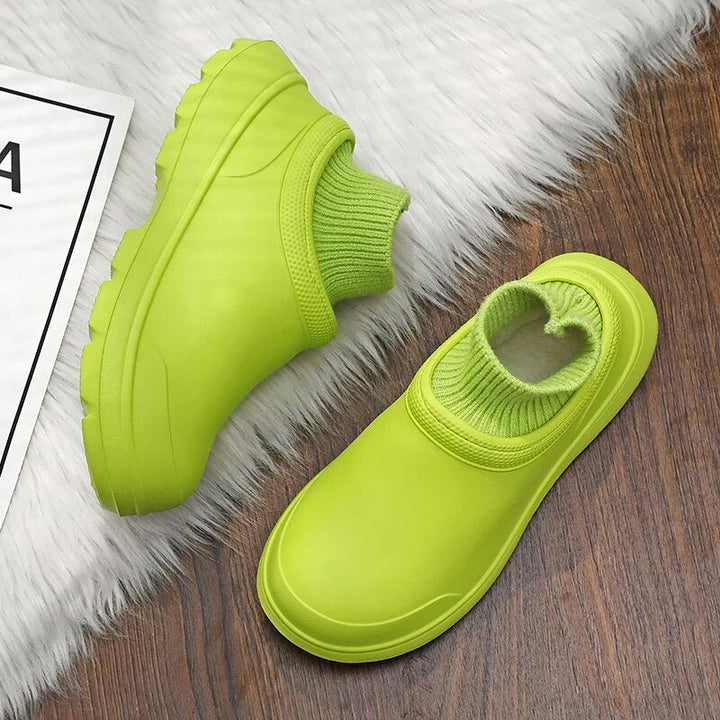 Stylish women's waterproof slip-on clogs featuring a cozy knitted ankle cuff, closed toe, & non-slip sole.