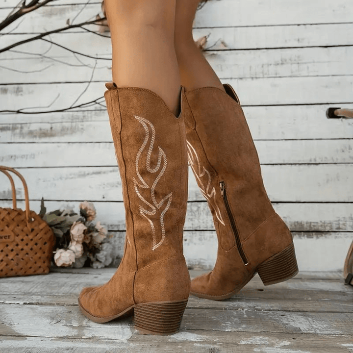 Embroidered women's cowboy boots with a block heel & pointed toe, blending classic Western style.