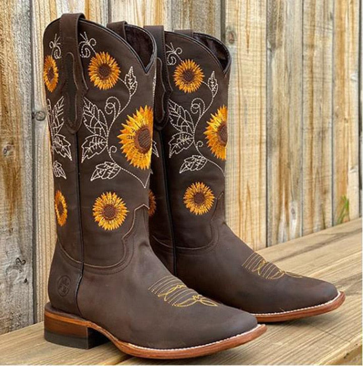 Fashionable women's mid-calf cowboy boots with eye-catching sunflower embroidery, pointed toe, and sturdy block heel.
