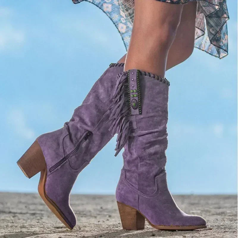 Bohemian women's mid-calf western boots featuring intricate turquoise studding, playful fringe, and block heel.