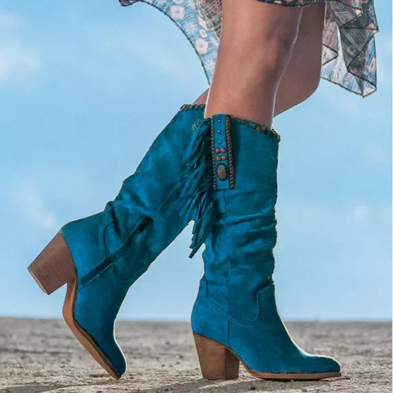 Statement western mid-calf slouch boots for women with vibrant turquoise studs, fringe, and a sturdy block heel.