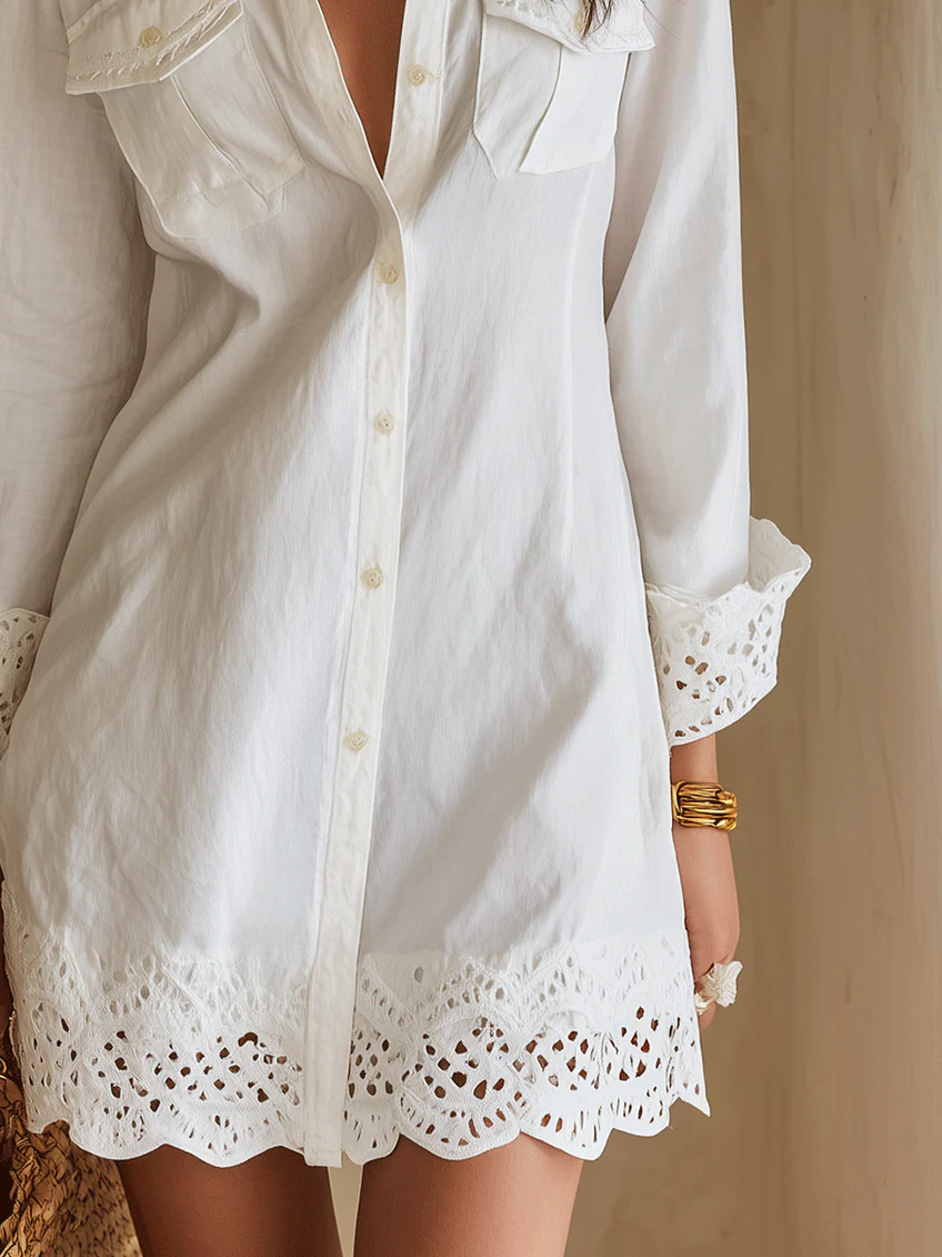 White collared shirt mini dress with button front & long sleeves, featuring a charming crochet hem. Ideal for casual summer.