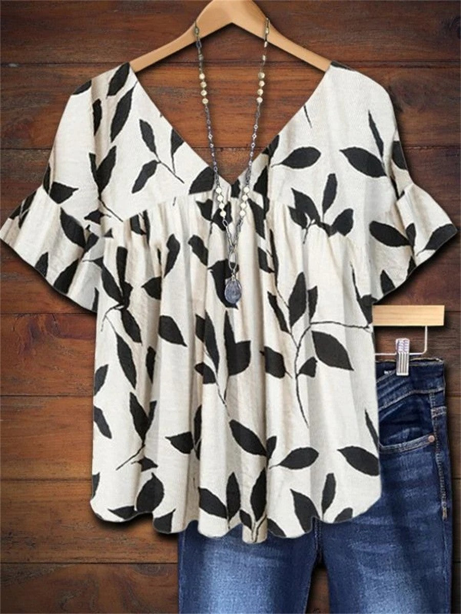 Women's white leaf print V-neck smock blouse with ruffle sleeves, perfect for summer casual elegant vacation style.